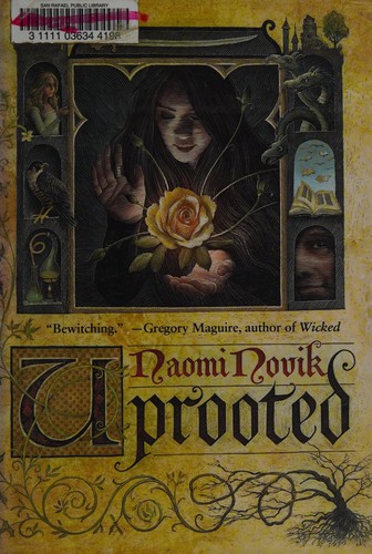 Cover of the 2015 Del Rey hardcover edition of Uprooted by Naomi Novik, showing a woman in an arched window surrounded by carved wood and a glowing rose.